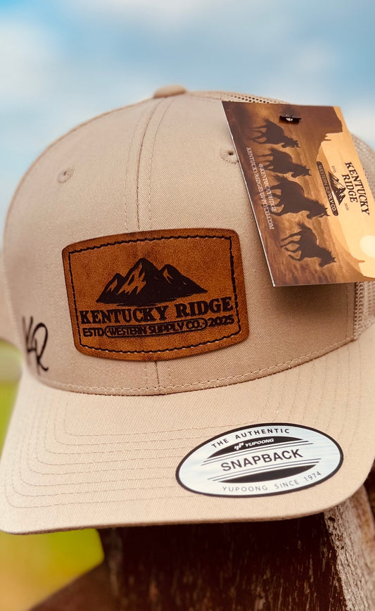 Beige cap with leather patch and tag on a blurred background