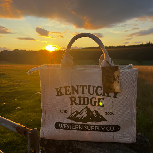 Canvas bag with 'Kentucky Ridge' branding against a sunset landscape