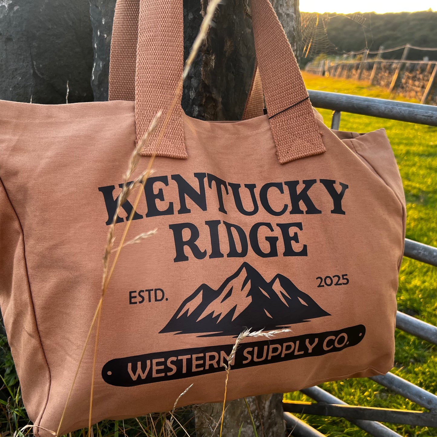 Brown tote bag with 'Kentucky Ridge' branding against a natural background